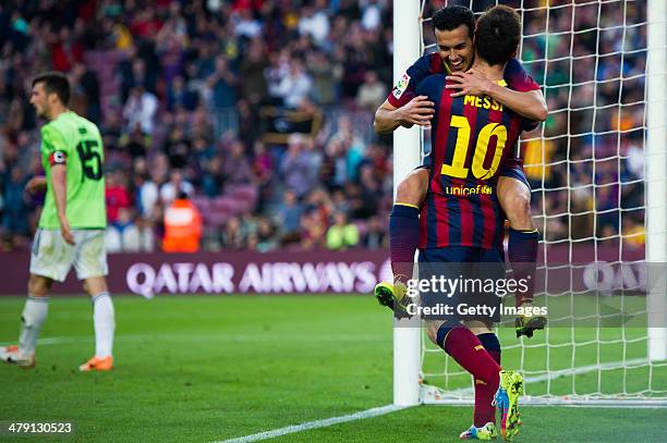 Pedro Rodriguez of FC Barcelona celebrates with his teammate Lionel Messi after scoring his team's seventh goal during the La Liga match between FC...