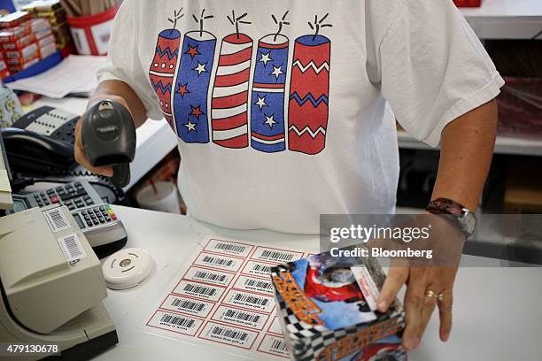 An employee rings up a customer's order at the Fireworks Supermarket store in Jasper, Tennessee, U.S., on Monday, June 29, 2015. As the 4th of July...