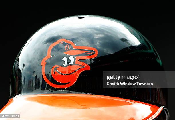The Baltimore Orioles logo is seen on a batting helmet during the game between the Boston Red Sox and the Baltimore Orioles at Fenway Park on June...