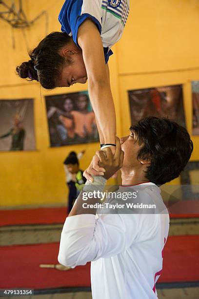 Two circus students practice a move before an upcoming performance on July 1, 2015 at Phare Ponleu Salpak in Battambang, Cambodia. Phare Ponleu...