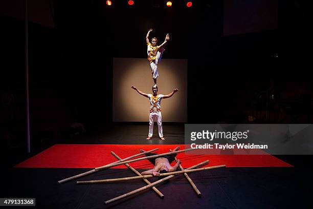 Cambodian circus artists perform in front of a crowd of foreign tourists on July 1, 2015 during a performance of "Eclipse" at Phare - The Cambodian...