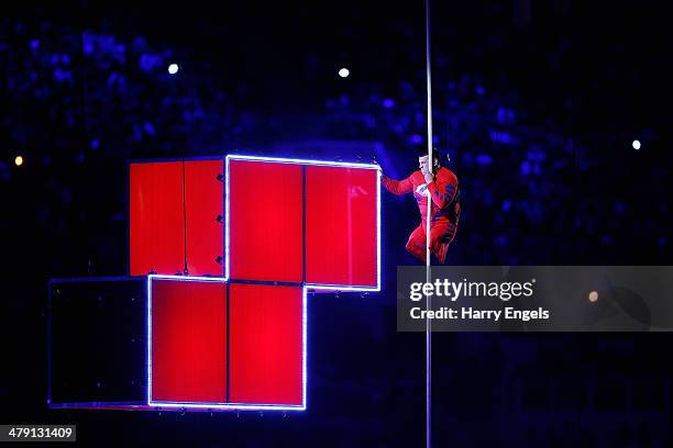 Aleksey Chuvashev, a rowing Paralympian, climbs a rope using just his hands to set off fireworks during the Closing Ceremony of the 2014 Paralympic...