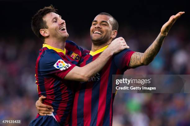 Lionel Messi of FC Barcelona celebrates with his teammate Daniel Alves after scoring his team's sixth goal during the La Liga match between FC...