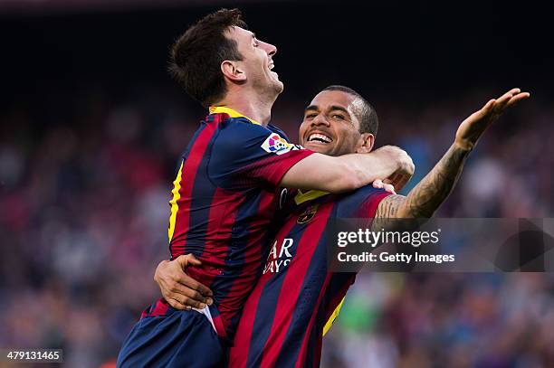 Lionel Messi of FC Barcelona celebrates with his teammate Daniel Alves after scoring his team's sixth goal during the La Liga match between FC...