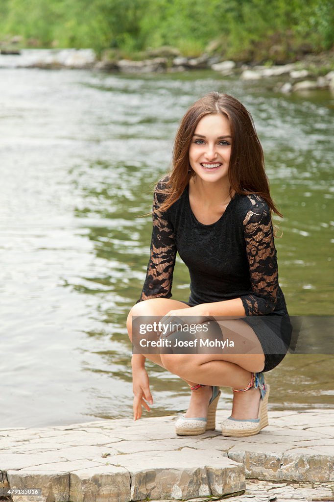 Crouching Types Front Portrait Of Young Brunette Woman Crouching By River High-Res ...