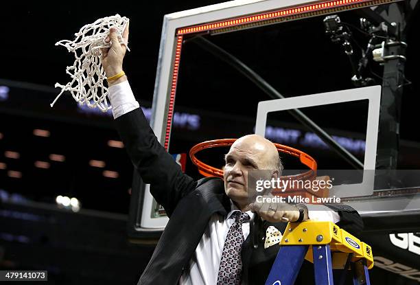 Head coach Phil Martelli of the Saint Joseph's Hawks holds up the net after cutting it down after defeating the Virginia Commonwealth Rams during the...