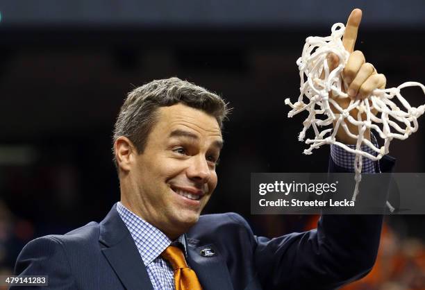 Virginia Cavaliers head coach Tony Bennett smiles after he cut down the net after they beat the Duke Blue Devils in the finals of the 2014 Men's ACC...