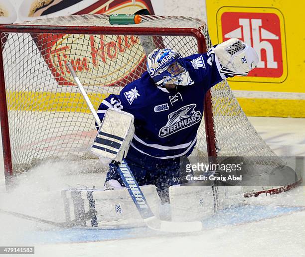 Spencer Martin of the Mississauga Steelheads stops a shot against the Kingston Frontenacs during game action on March 16, 2014 at the Hershey Centre...