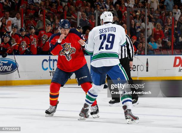 Krys Barch of the Florida Panthers and Tom Sestito of the Vancouver Canucks fight during first period action at the BB&T Center on March 16, 2014 in...