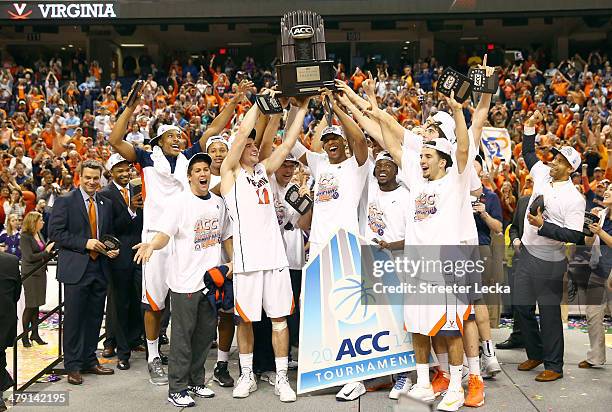 The Virginia Cavaliers celebrate with the trophy after they beat the Duke Blue Devils in the finals of the 2014 Men's ACC Basketball Tournament at...