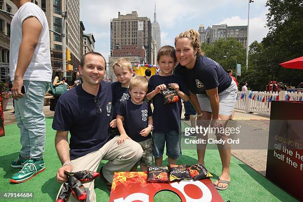 Firefighters and their families attend the popchips Crazy Hot BBQ hosted by Ali Larter for the FDNY at Flatiron Plaza on July 1, 2015 in New York...