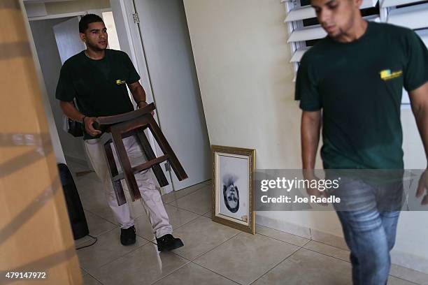 La Rosa del Monte movers pack up Yessenia Puente's apartment as she prepares to move to Orlando, Florida this weekend on July 1, 2015 in San Juan,...