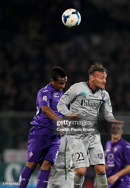 Tiberio Guarente of AC Chievo Verona competes for the ball with Anderson of ACF Fiorentina during the Serie A match between ACF Fiorentina and AC...