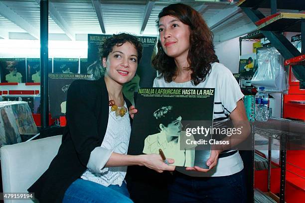 Mexican singer Natalia Lafourcade signs autographs to her fans during a sale of her vynil records on June 30, 2015 in Mexico City, Mexico.