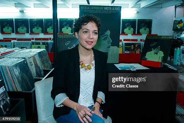 Mexican singer Natalia Lafourcade signs autographs to her fans during a sale of her vynil records on June 30, 2015 in Mexico City, Mexico.