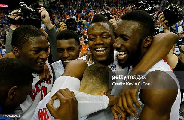 Scottie Wilbekin, Will Yeguete, Dorian Finney-Smith and Patric Young of the Florida Gators celebrate their 61 to 60 win over the Kentucky Wildcats in...