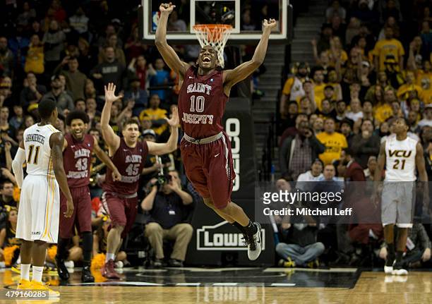 Guard Langston Galloway, forward Deandre' Bembry, and forward Halil Kanacevic of the Saint Joseph's Hawks celebrate their win over the VCU Rams in...
