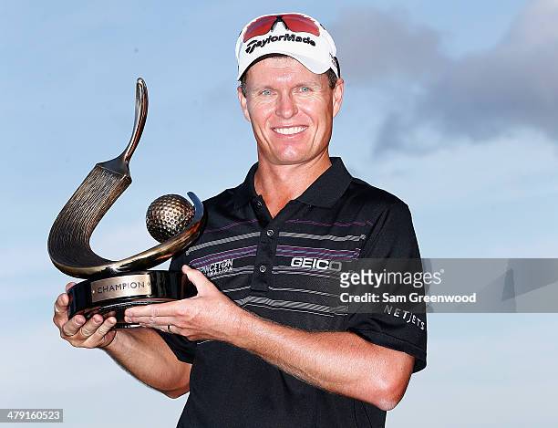 John Senden of Australia stands with his trophy after winning the Valspar Championship at Innisbrook Resort and Golf Club on March 16, 2014 in Palm...