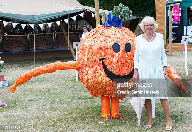 Camilla, Duchess of Cornwall poses with Mr Men character, Mr Tickle as vists The Hampton Court Flower Show at Hampton Court Palace on July 1, 2015 in...