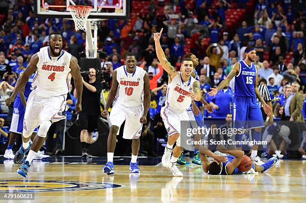 Patric Young, Dorian Finney-Smith, and Scottie Wilbekin of the Florida Gators celebrate as the horn blows to win the SEC Men's Basketball Tournament...