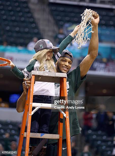 Adreian Payne of the Michigan State Spartans celebrates with 8 year old Lacey Hullsworth after the 69-55 win over the Michigan Wolverines during the...