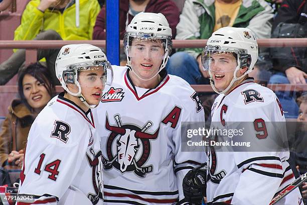 Rhyse Dieno, Haydn Fleury, and Conner Bleackley of the Red Deer Rebels celebrate Fleury's goal against the Edmonton Oil Kings during a WHL game at...