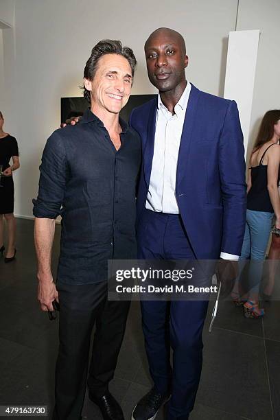 Lawrence Bender and Oswald Boateng attend a private view of "Raw Footage" at The Opera Gallery on July 1, 2015 in London, England.