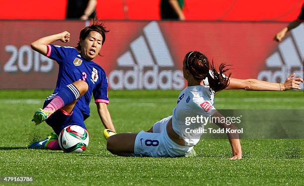 Jill Scott of England and Azusa Iwashimizu # of Japan slide in for the ball during the FIFA Women's World Cup Canada Semi Final match between England...