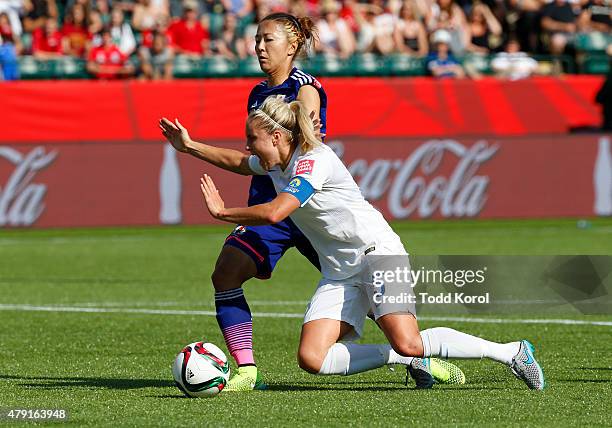Yuki Ogimi of Japan trips up Steph Houghton of England resulting in a penalty shot and a goal for England during the FIFA Women's World Cup Canada...