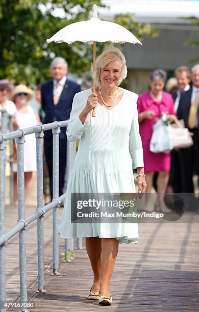 Camilla, Duchess of Cornwall shelters under a parasol as she attends The Hampton Court Flower Show at Hampton Court Palace on July 1, 2015 in London,...