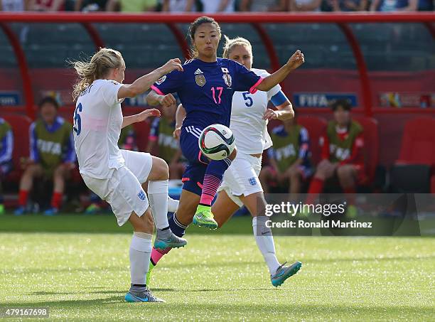 Yuki Ogimi of Japan battles Katie Chapman and Steph Houghton of England during the FIFA Women's World Cup Semi Final match between Japan and England...