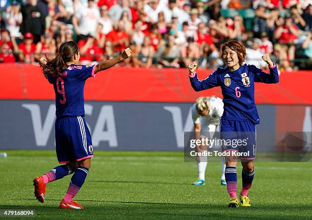 Nahomi Kawasumi and Mizuho Sakaguchi of Japan celebrate after Laura Bassett of England scored on her own team in the final minutes of the game during...