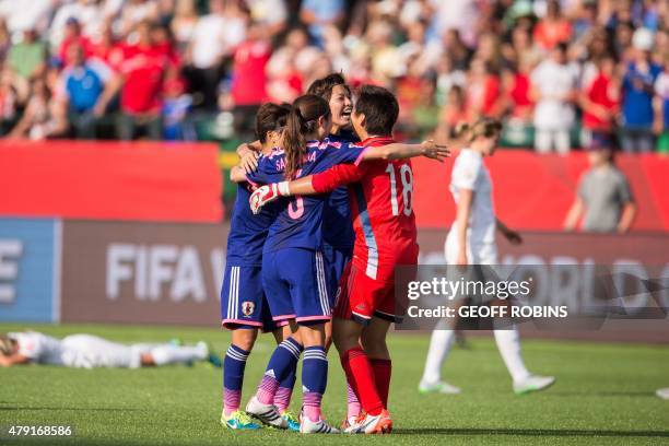 Japan players celebrate victory over England in their FIFA Women's World Cup semi-final at Commonwealth Stadium in Edmonton, Canada, on July 1, 2015....
