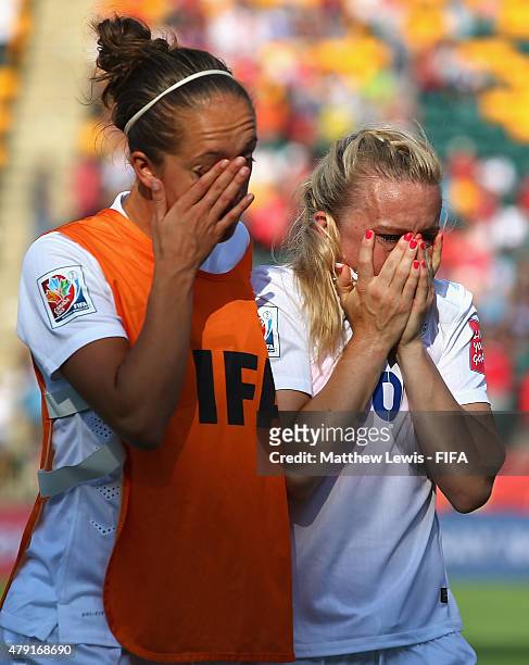 Jo Potter of England consoles Laura Bassett after their team lost to Japan during the FIFA Women's World Cup 2015 Semi Final match between Japan and...