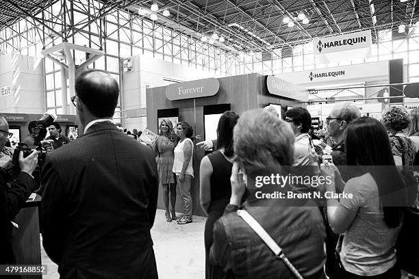 Author Christie Brinkley poses for photographs with fans during BookExpo America held at the Javits Center on May 29, 2015 in New York City.