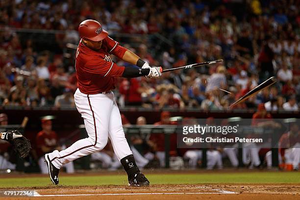 Yasmany Tomas of the Arizona Diamondbacks breaks his bat as he hits a ground ball out during the first inning of the MLB game against the Los Angeles...