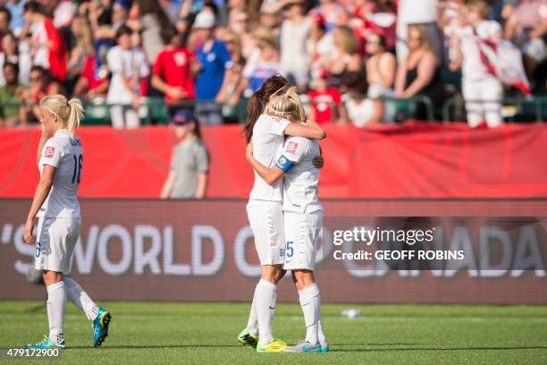 England's Jill Scott and Steph Houghton hold each other following their last second loss to Japan in their semifinal match at the FIFA Women's World...