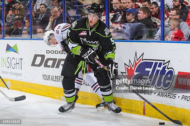 Ashton Sautner of the Edmonton Oil Kings checks Adam Musil of the Red Deer Rebels during a WHL game at Rexall Place on March 16, 2014 in Edmonton,...