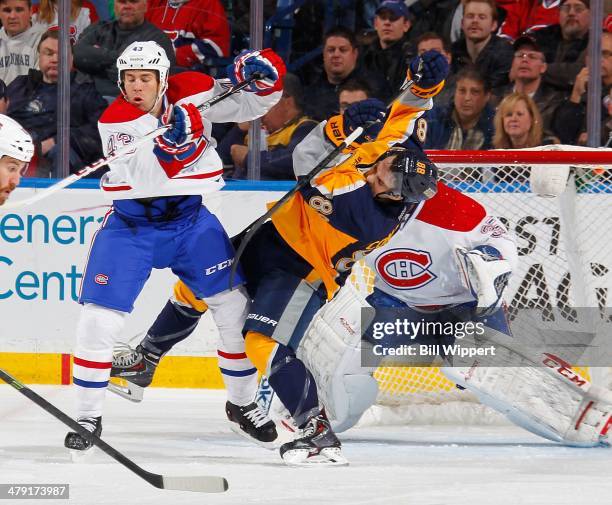 Marcus Foligno of the Buffalo Sabres gets upended by Mike Weaver of the Montreal Canadiens on March 16, 2014 at the First Niagara Center in Buffalo,...