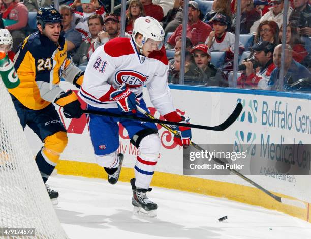 Lars Eller of the Montreal Canadiens carries the puck against Zenon Konopka of the Buffalo Sabres at First Niagara Center on March 16, 2014 in...