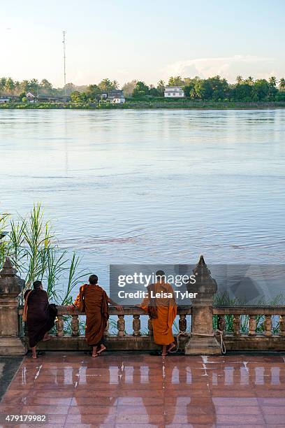 Monks look towards Laos from the Thai town of Nong Khai in Issarn Province.