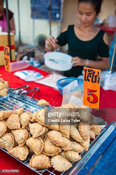 Curry puffs for sale at a night market set up long the Mekong River in the Issarn town of Nong Khai. Curry puffs are a SE Asian version of samosa,...