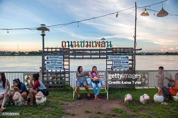 People relax at a night market set up long the Mekong River in the Issarn town of Nong Khai.