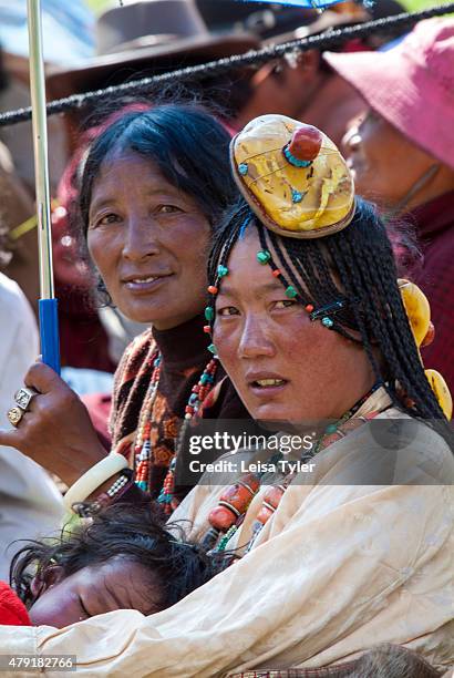 Khampa nomads enjoying a day of traditional singing and dancing at a small summer festival in the remote Sichuan county of Axu. Plagued by long...