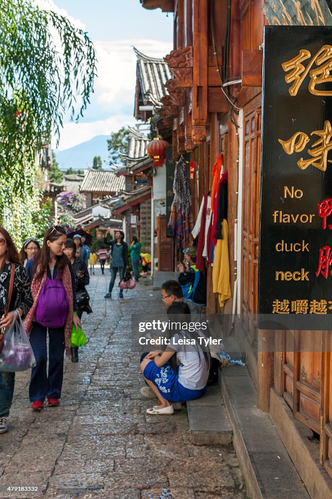A sign board for a restaurant in Lijiang old town, a Naxi...