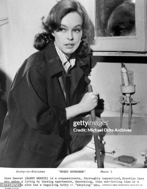 Actress Sandy Dennis with a plunger in a scene of the Warner Bros. Movie "Sweet November" circa 1968.