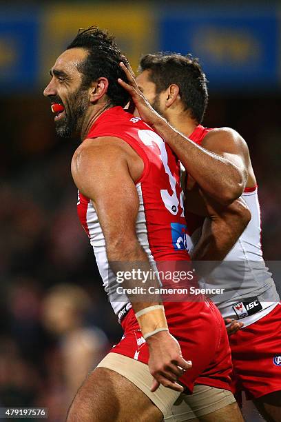 Adam Goodes of the Swans celebrates kicking a goal with team mate Lewis Jetta during the round 14 AFL match between the Sydney Swans and the Port...