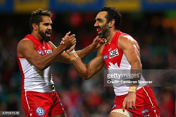 Adam Goodes of the Swans celebrates kicking a goal with team mate Lewis Jetta during the round 14 AFL match between the Sydney Swans and the Port...