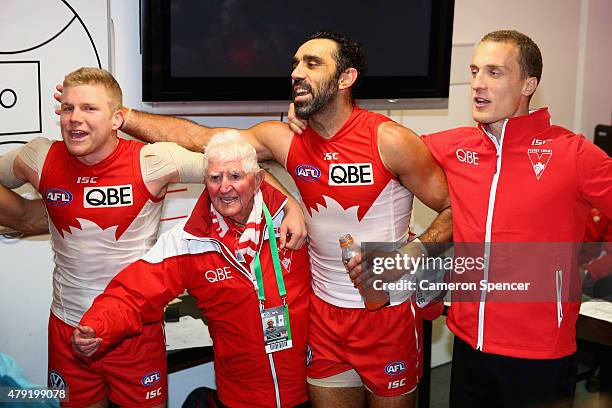 Dan Hannebery, Adam Goodes and Ted Richards of the Swans sing the team song after winning the round 14 AFL match between the Sydney Swans and the...