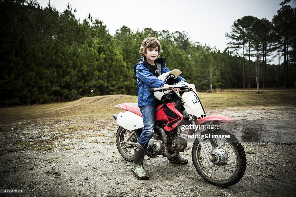 Boy (9) with dirtbike motorcycle